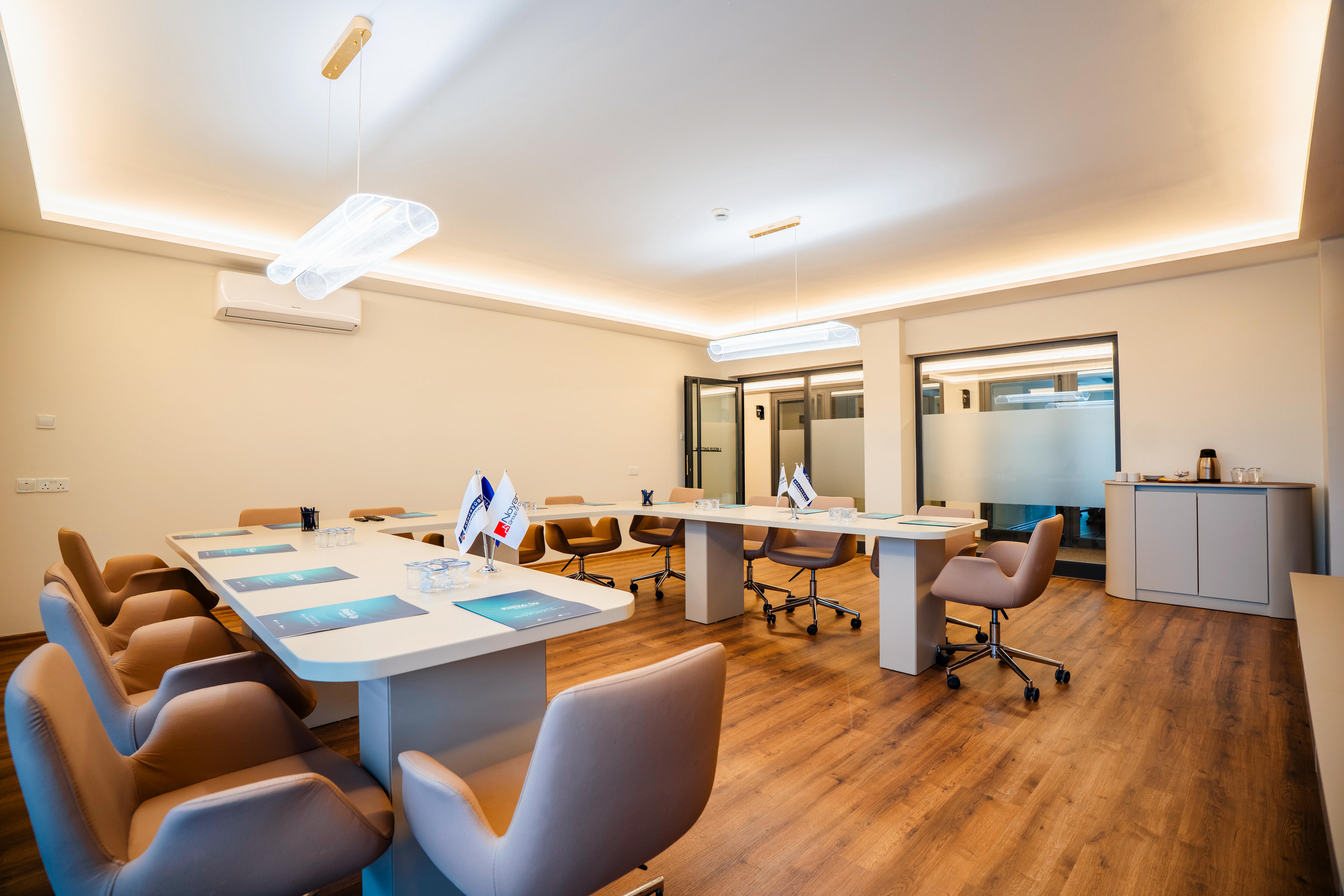 White conference room with modern pendant light