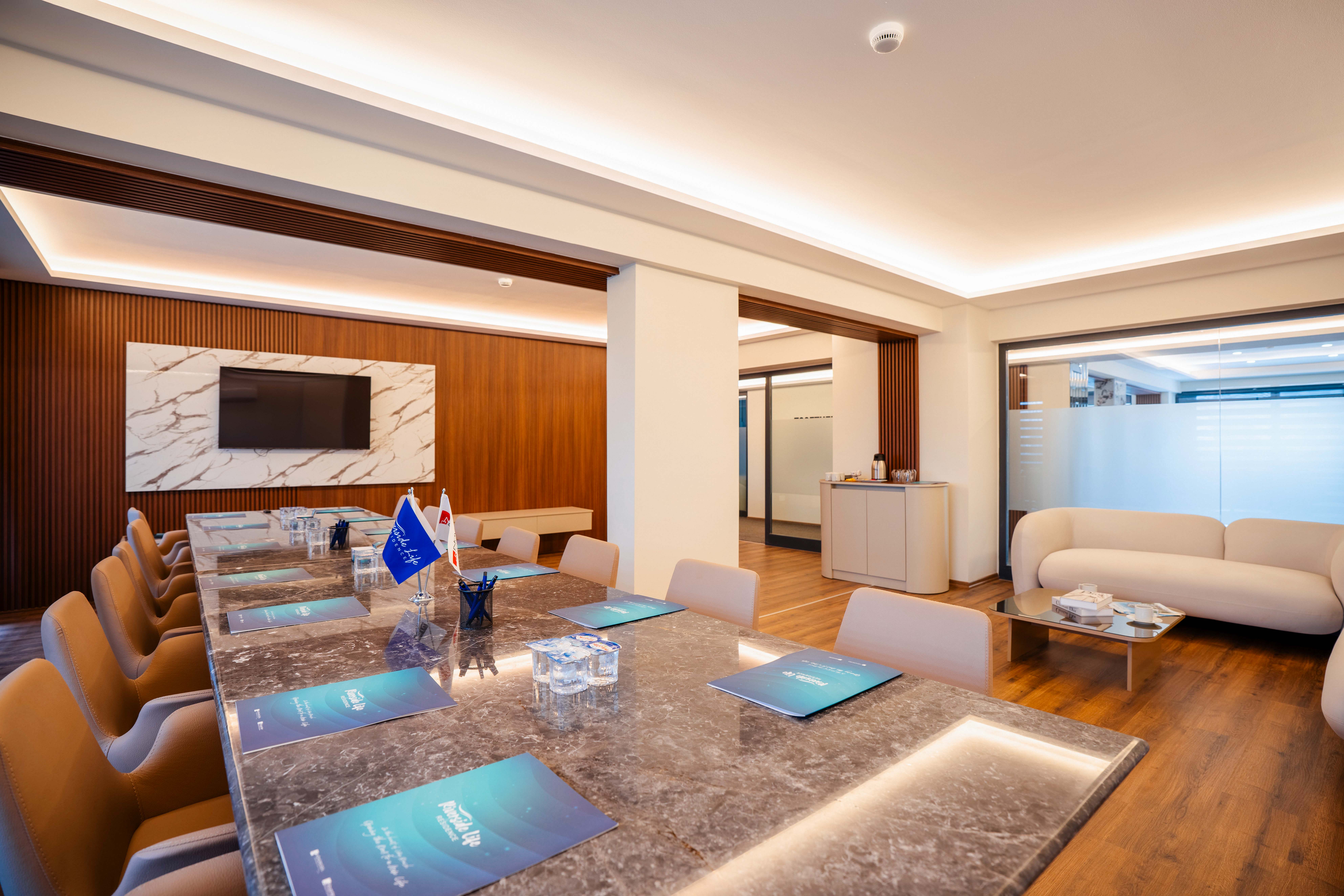 Meeting room with marble conference table and lounge area