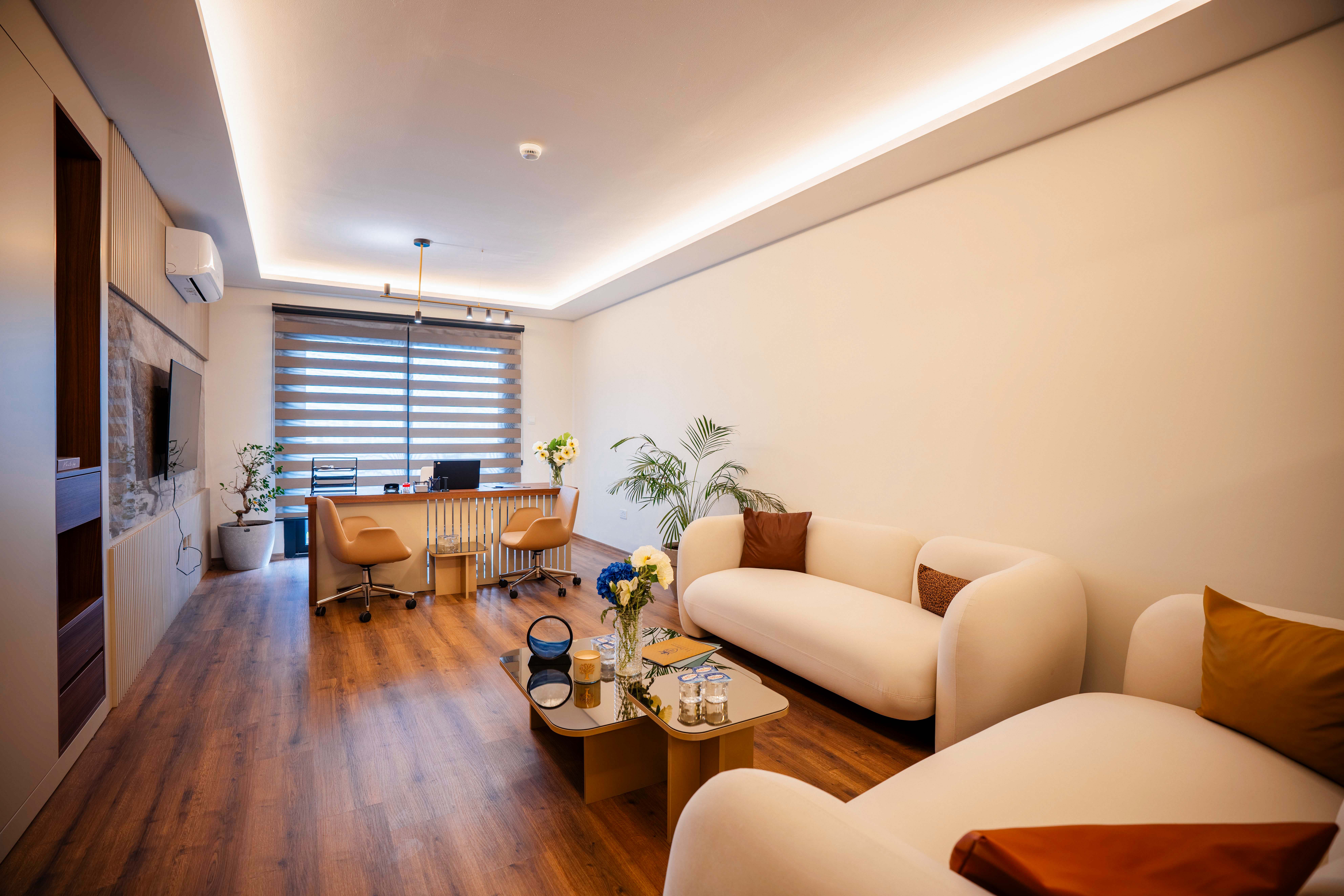 Executive office with comfortable white sofas and desk area